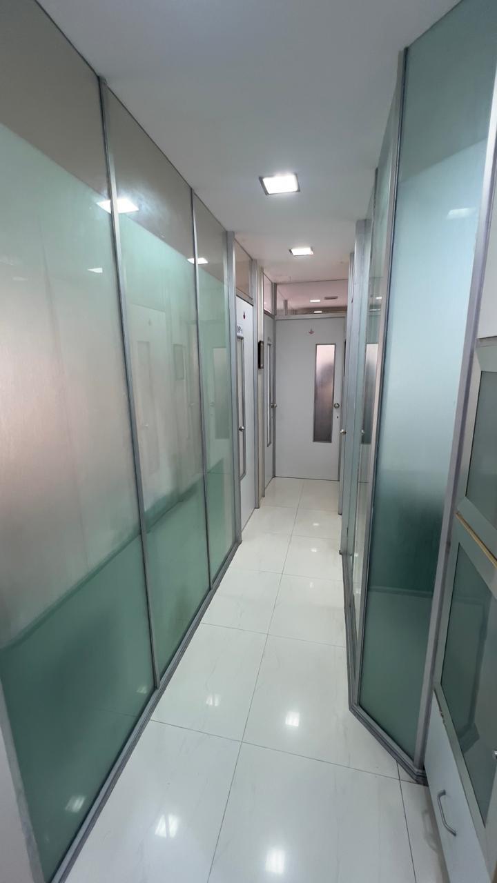Glass-panelled passage leading to treatment rooms